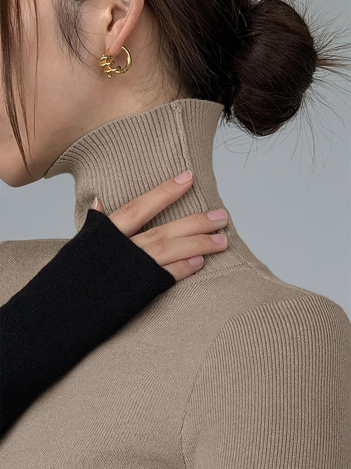 Top de punto de manga larga con cuello perkins y patchwork asimétrico