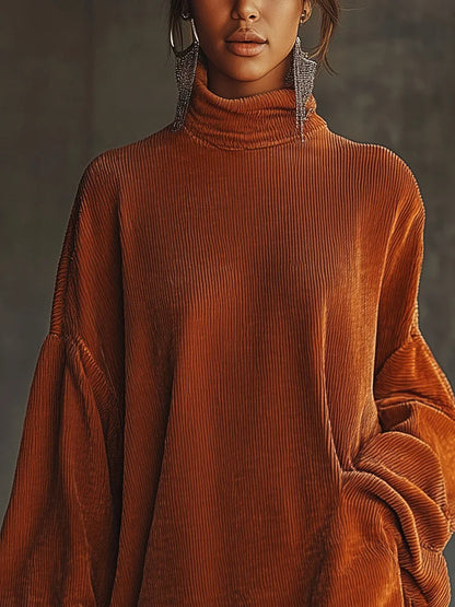 Vestido holgado de pana naranja con cuello alto y bajo de flecos