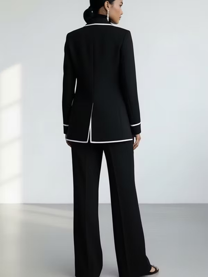 Traje de dos piezas negro: blazer con vivos en contraste y pantalón de pierna ancha