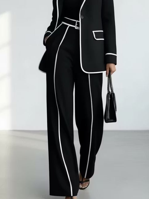 Traje de dos piezas negro: blazer con vivos en contraste y pantalón de pierna ancha
