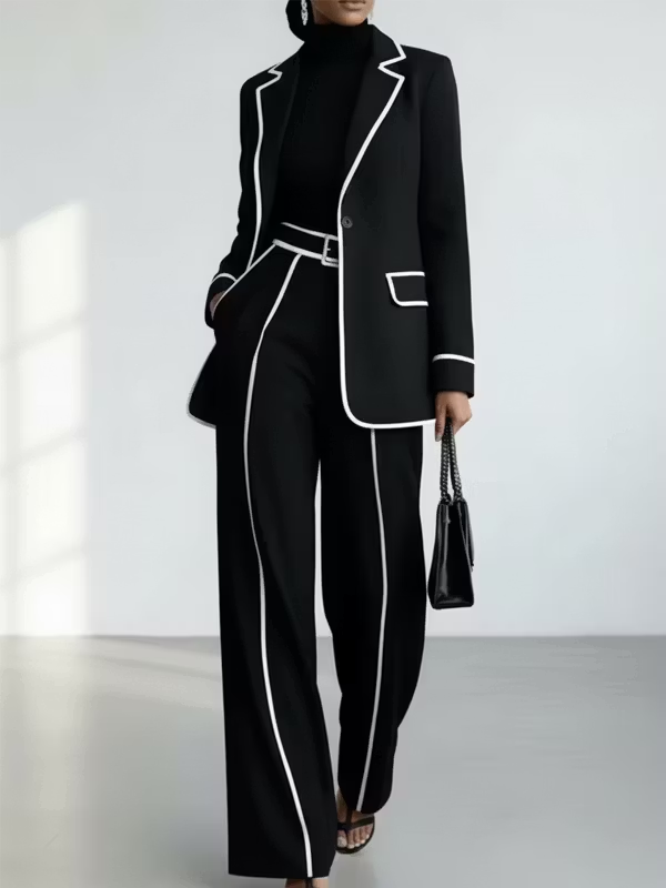Traje de dos piezas negro: blazer con vivos en contraste y pantalón de pierna ancha