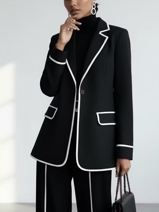 Traje de dos piezas negro: blazer con vivos en contraste y pantalón de pierna ancha