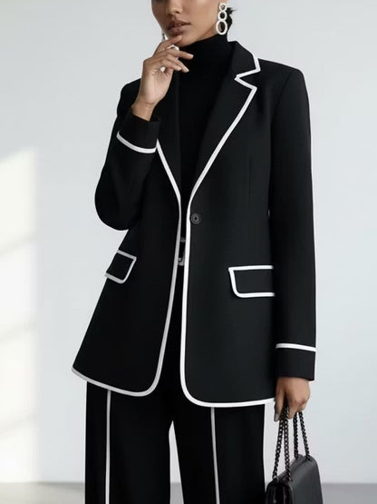 Traje de dos piezas negro: blazer con vivos en contraste y pantalón de pierna ancha