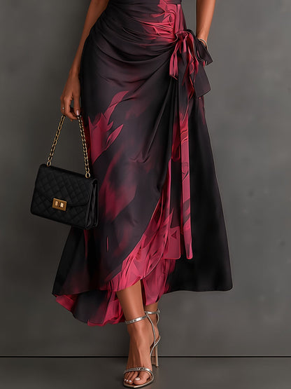 Vestido midi cruzado con estampado abstracto rojo y negro, cuello camisero en V, manga corta, lazo en la cintura y bajo asimétrico con volantes